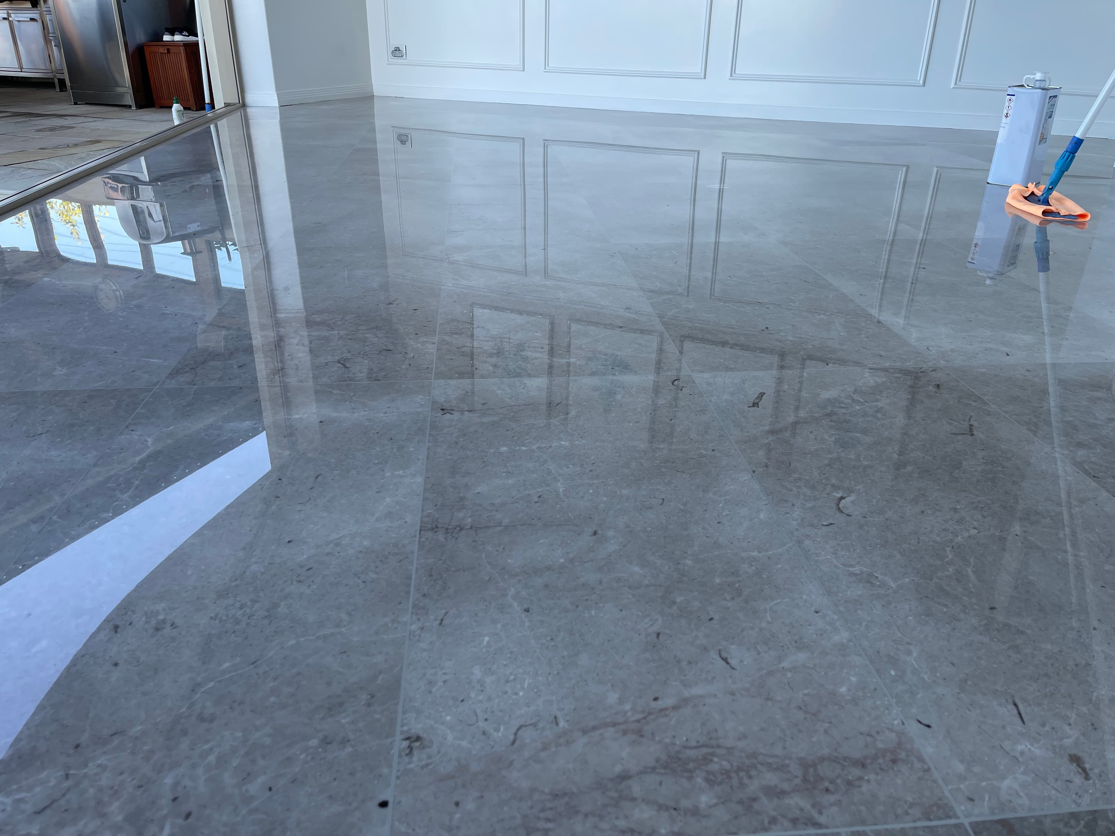 The same marble floor after grinding, honing and polishing to a reflective finish