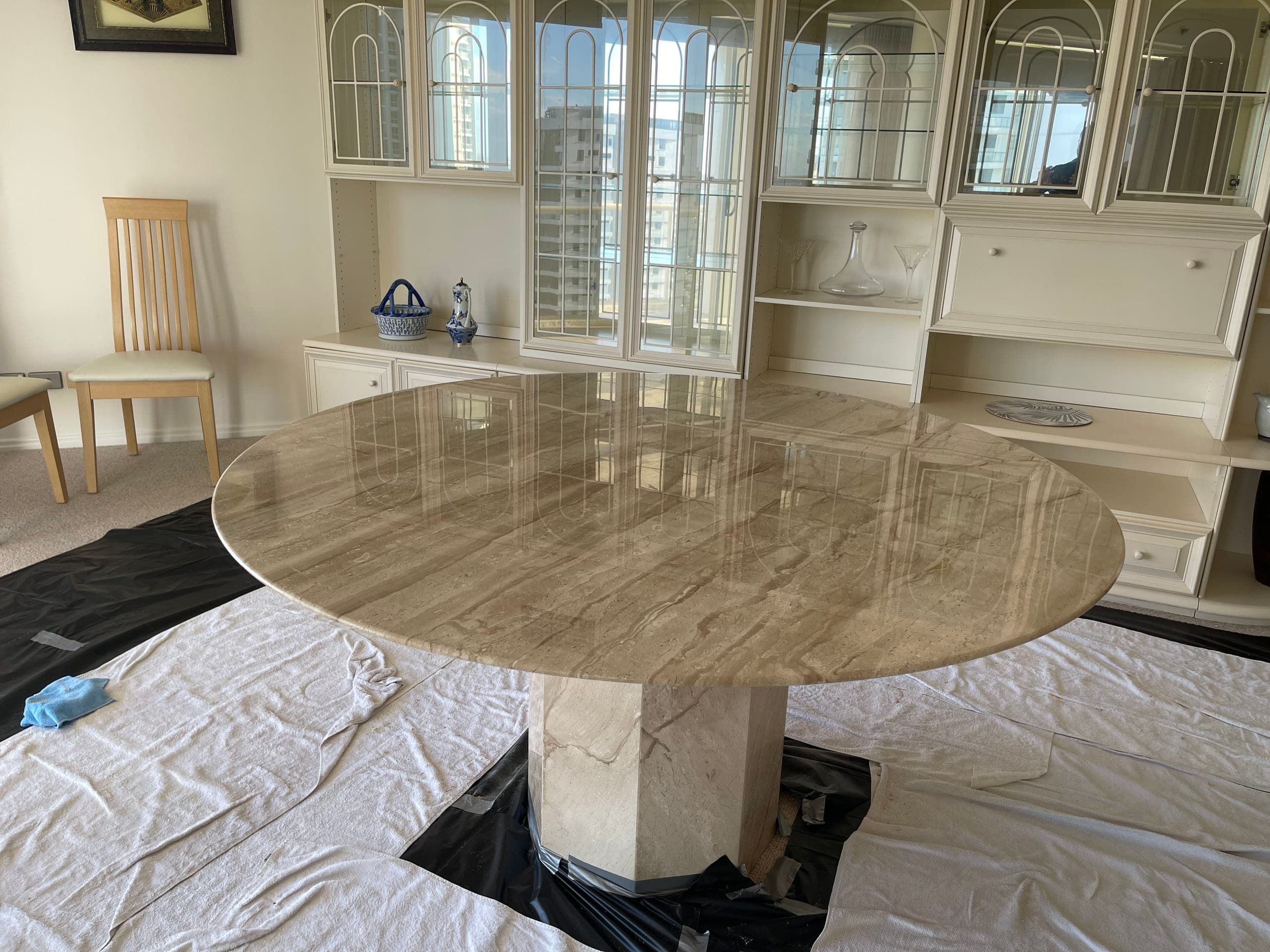 Restored round natural stone dining table back in the apartment with the repair invisible