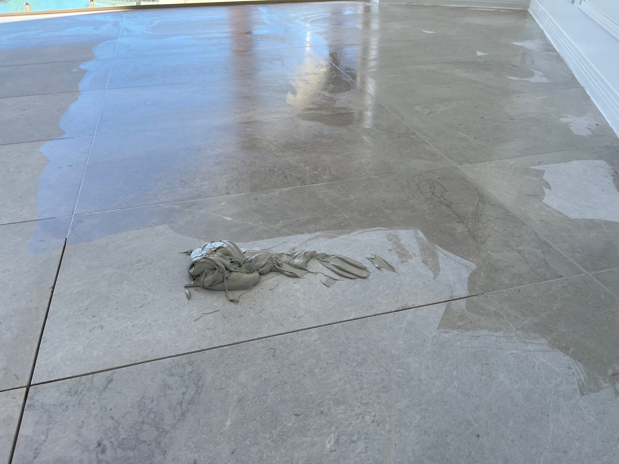 Freshly filled joints across the matte dining-area marble floor