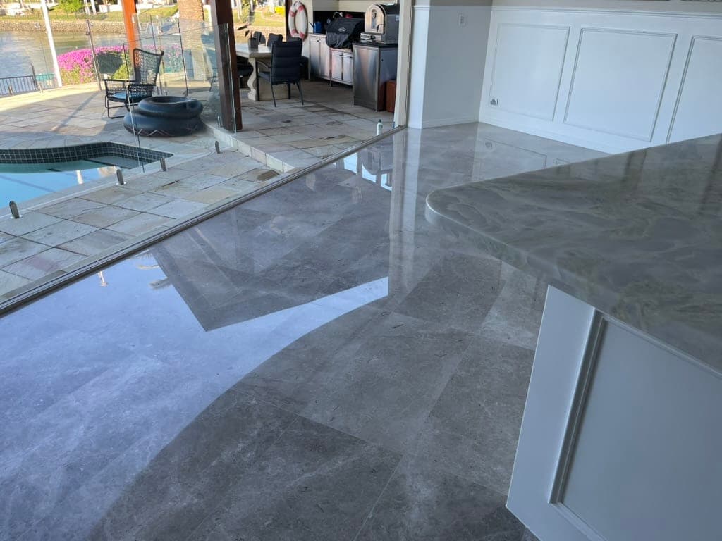 Dining-area marble floor during polishing, reflections beginning to appear