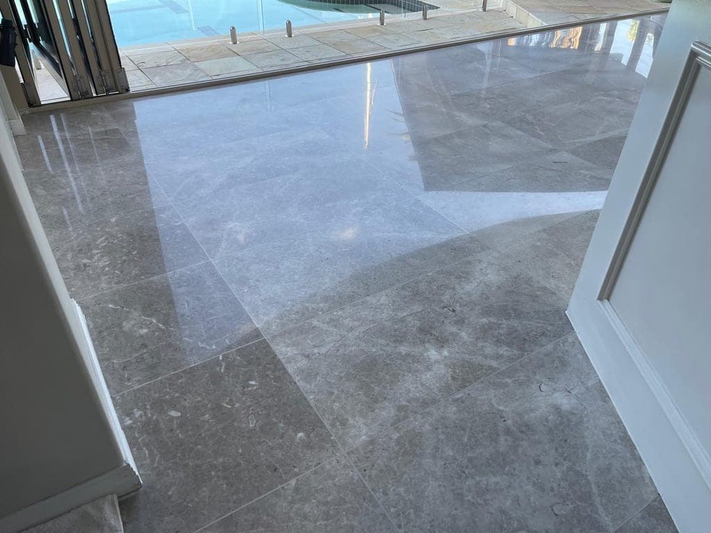 Marble floor gaining a glossy reflection through polishing