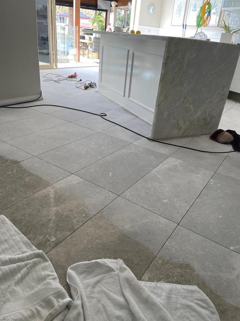 Grey marble floor in the dining area showing wear before the first grind