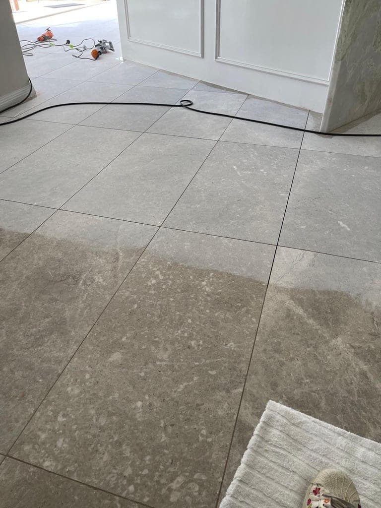 Tired grey marble dining floor immediately before grinding begins