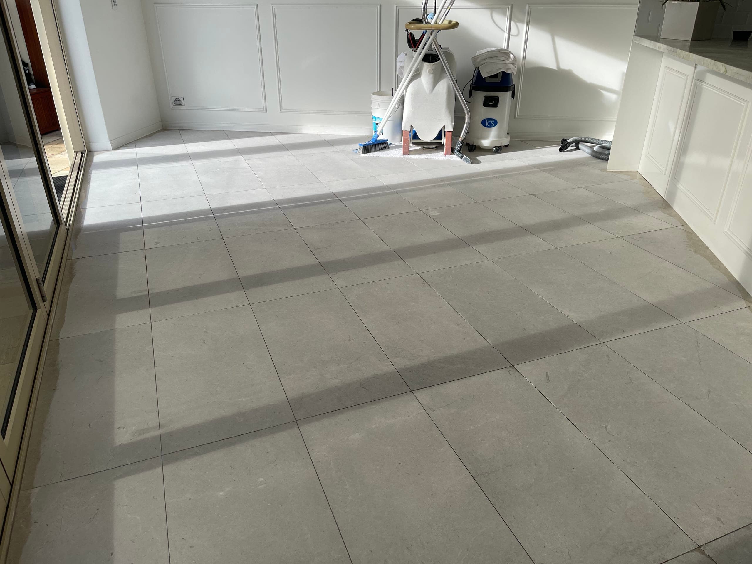 First grinding pass across the dining-area marble floor