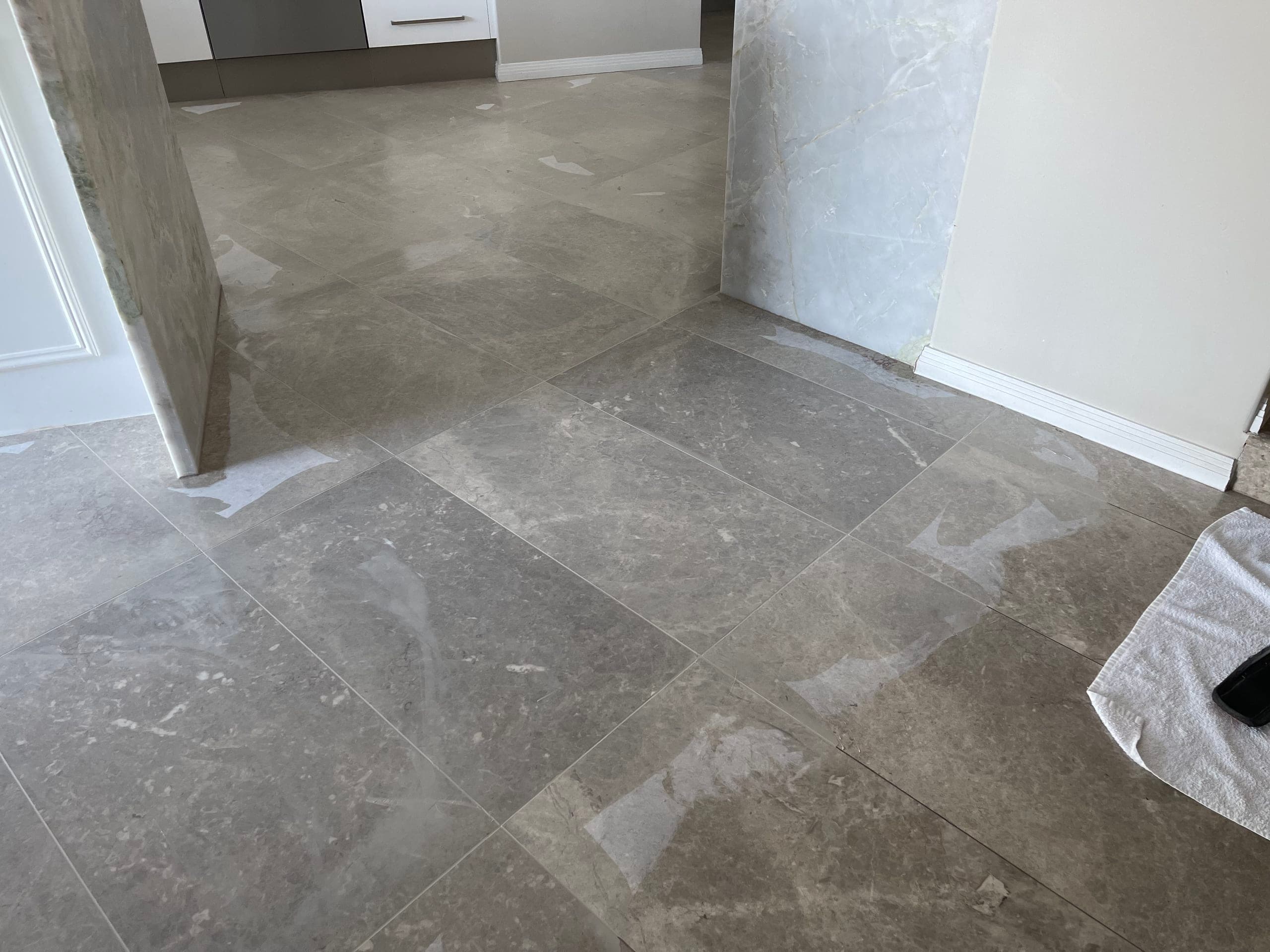 Matte kitchen marble floor with joints filled, mid-restoration