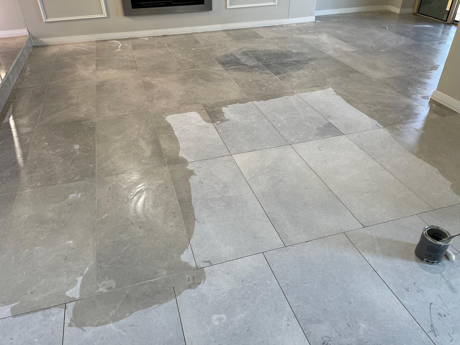 Planetary grinding machine working the living-area marble floor as joints are refilled