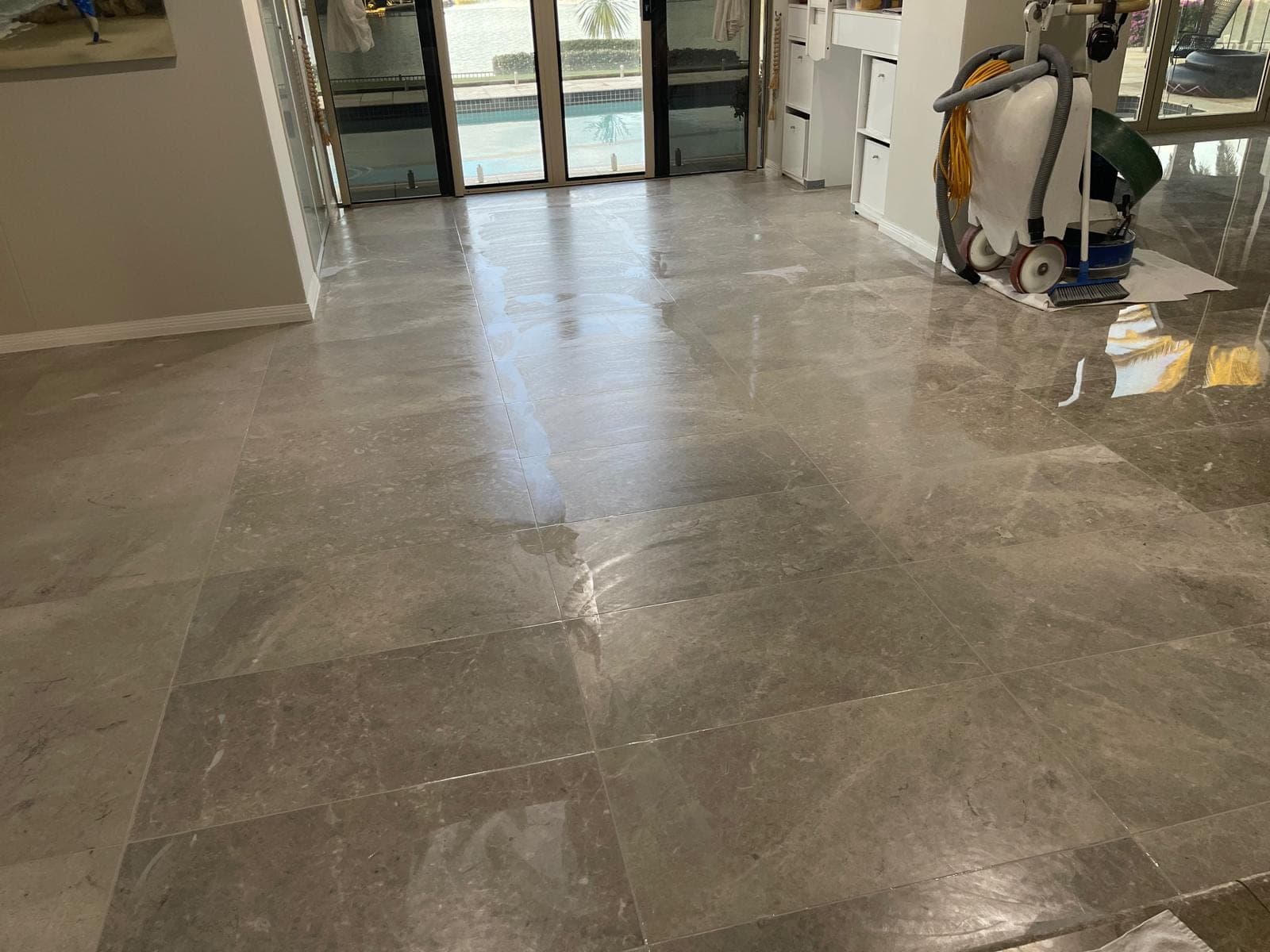 Matte ground marble floor with freshly refilled joints across the living area