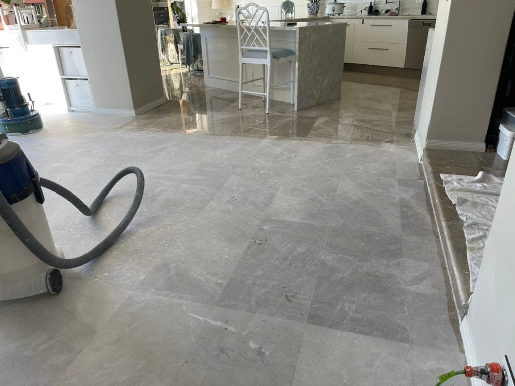 Living-area marble floor during the second grind, beginning to show light reflection