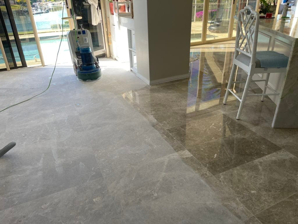 Smoothing pass over the grey marble floor with reflections starting to form