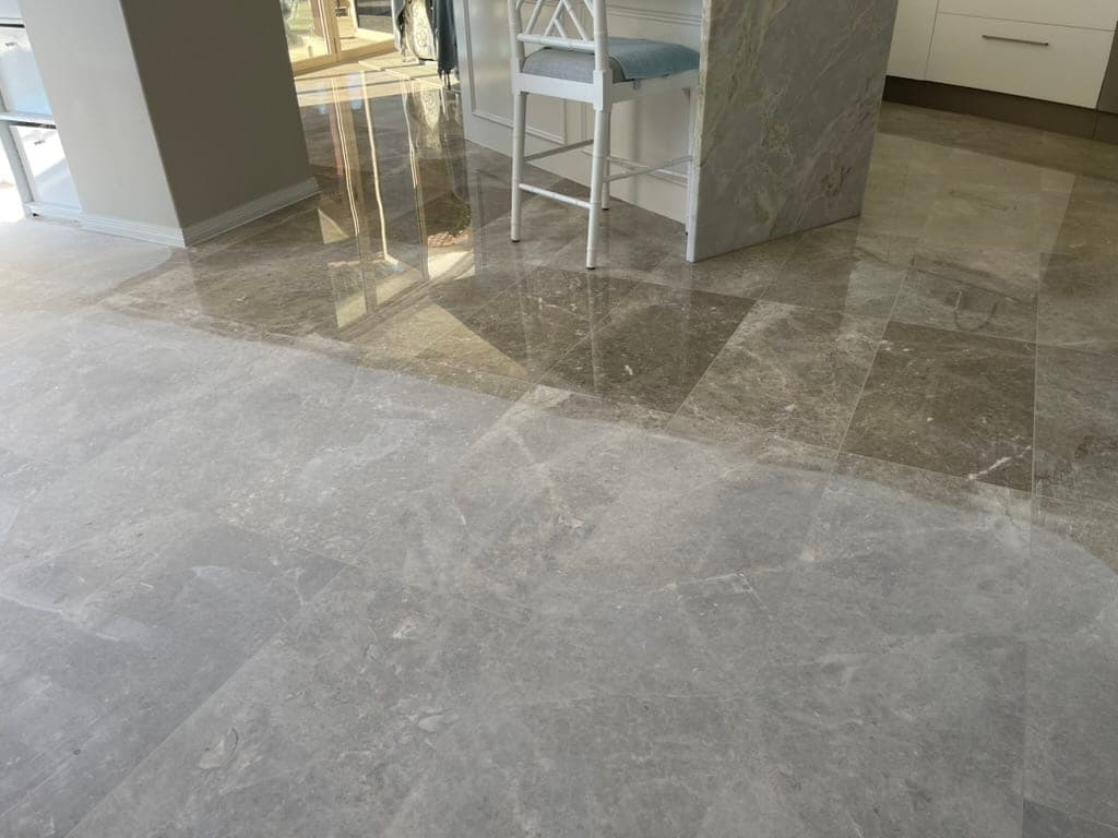 Marble floor near the end of grinding, the surface now largely even and reflective
