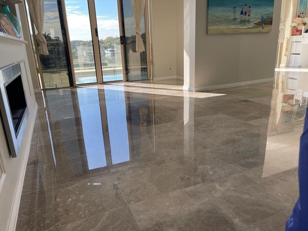 Finished, reflective marble floor across the open-plan living area