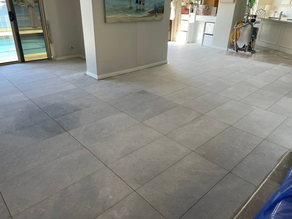 Ground marble floor showing an even matte surface across the living area during the first grind