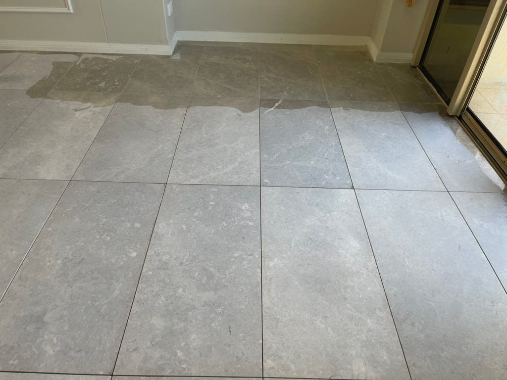 Marble floor part-way through grinding while the tile joints are being refilled