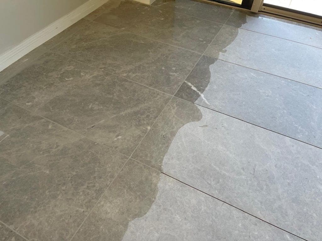 Close view of a marble tile joint being refilled during restoration