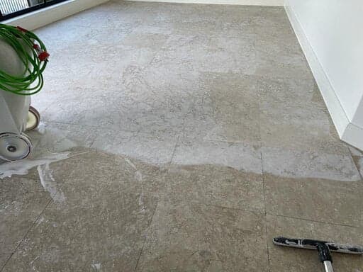 Diamond grinding removing a failed surface coating from stone