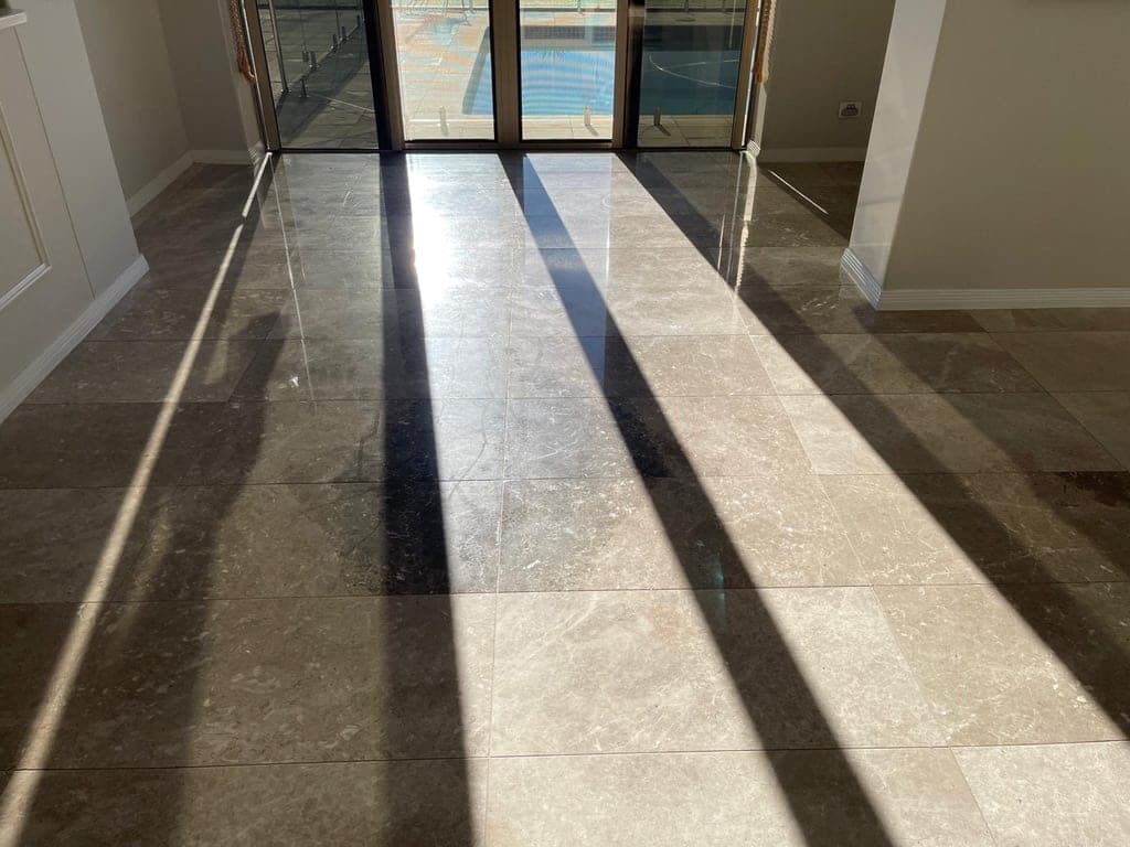 Grey marble living-area floor before restoration, dull and unpolished with hard shadow lines