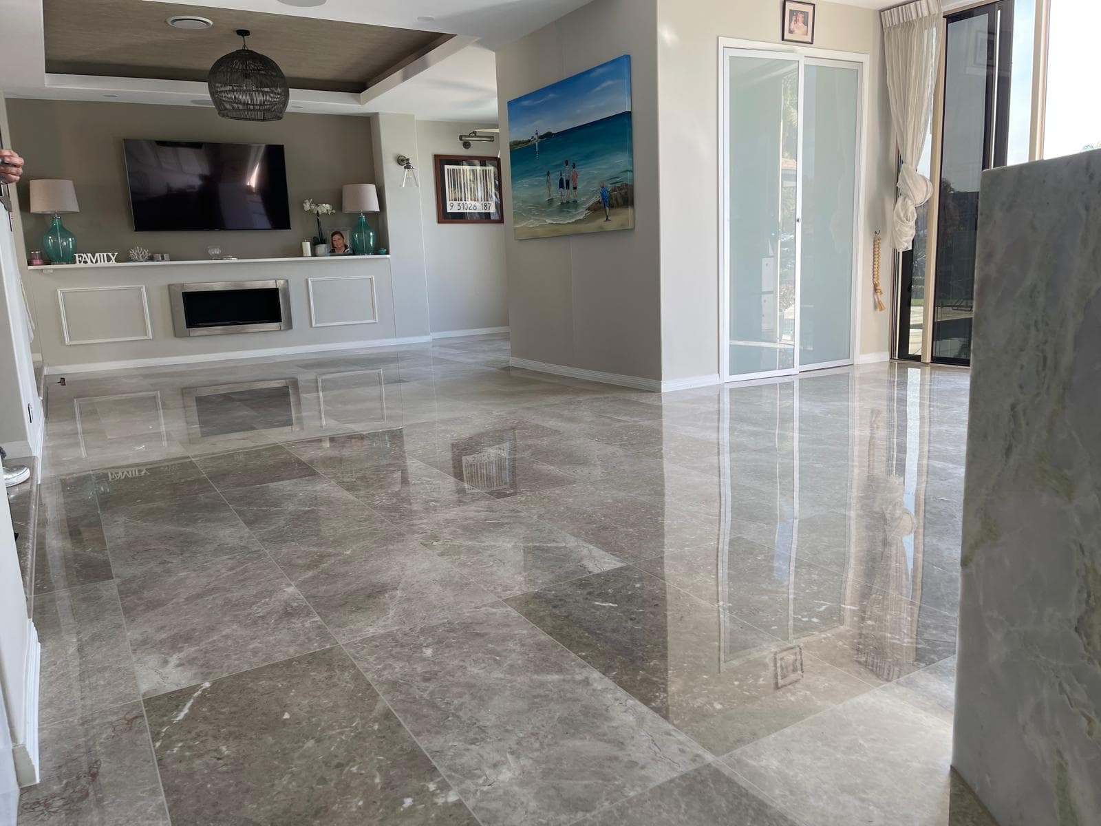 Polished marble floor reflecting natural light in a Hope Island penthouse living area