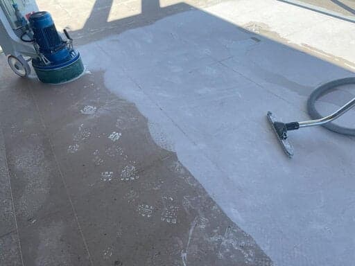 Marble floor covered in grinding slurry during the first cut